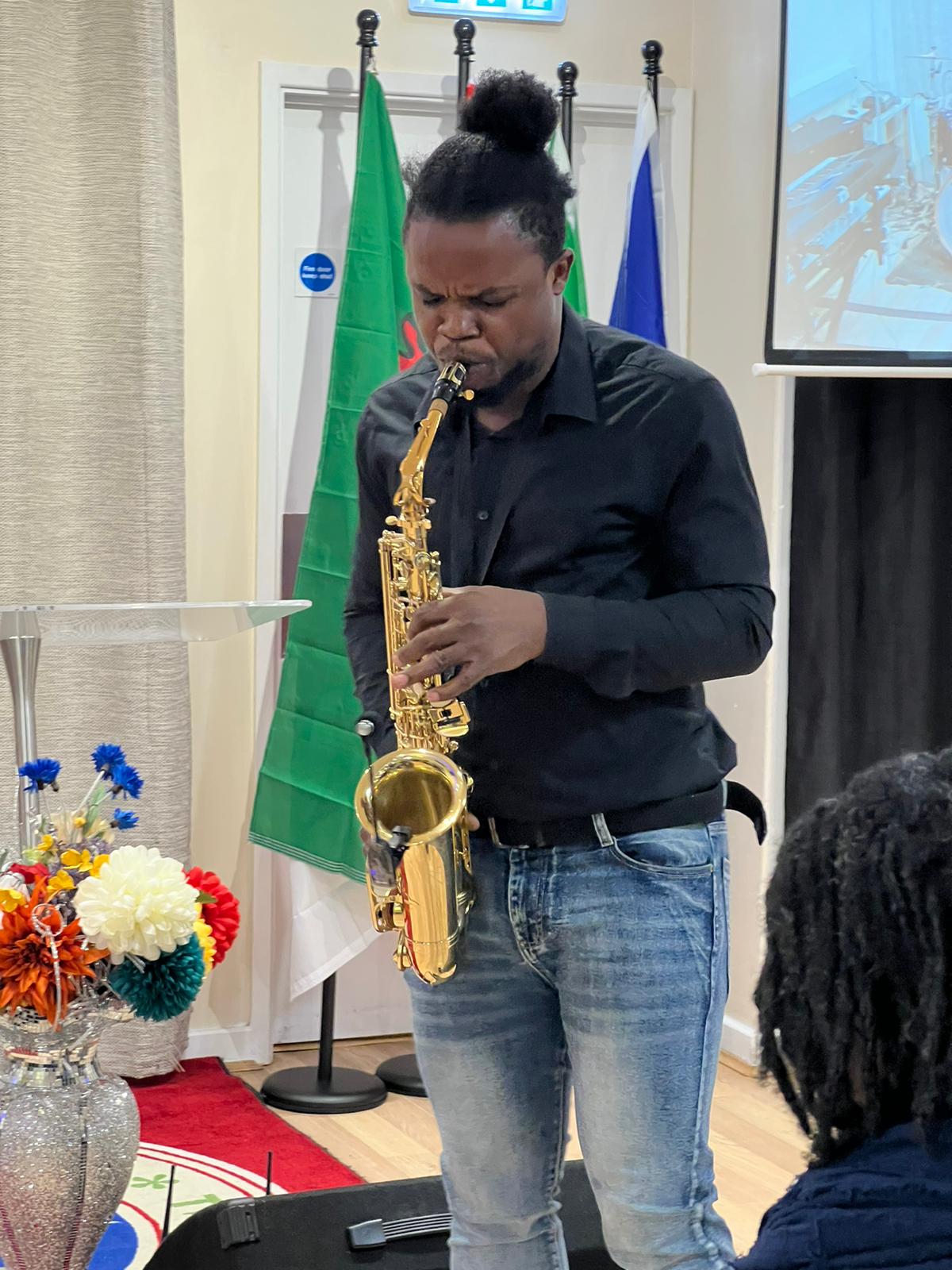Genesis Odeh performing saxophone at Hour of the Supernatural, March 2024